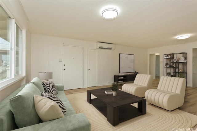 living room with light wood finished floors and a wall mounted AC