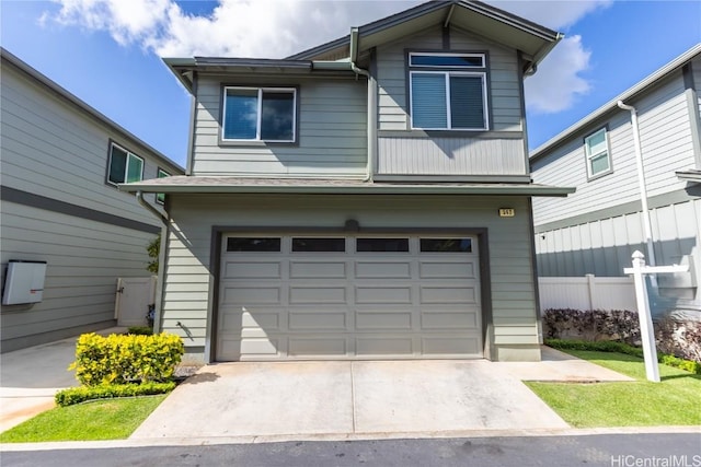 view of front of property featuring a garage, fence, and driveway