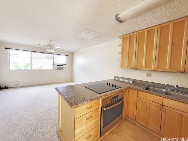 kitchen with oven, black electric cooktop, a sink, open shelves, and dark countertops