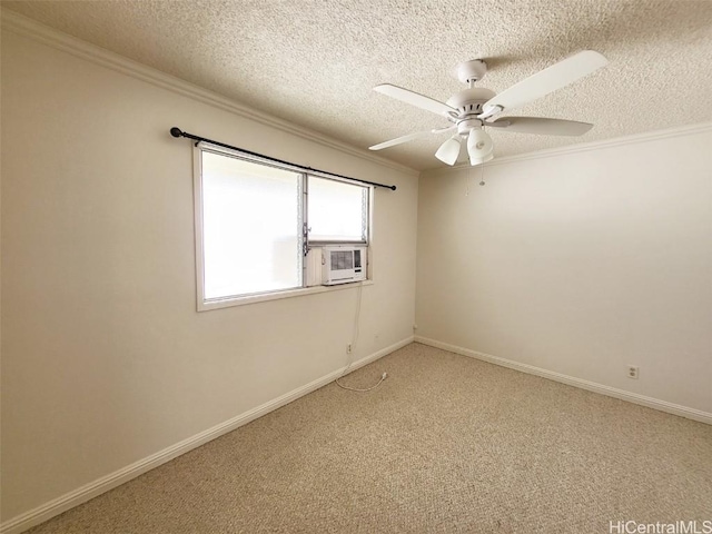 empty room with baseboards, ceiling fan, ornamental molding, a textured ceiling, and carpet floors