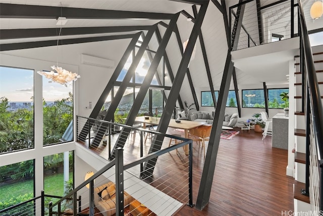 interior space with a wall unit AC, vaulted ceiling with beams, and a notable chandelier