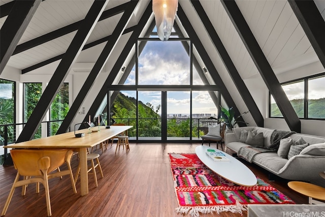 sunroom featuring vaulted ceiling with beams and a wealth of natural light