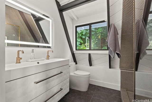 bathroom featuring tile patterned flooring, toilet, vanity, baseboards, and beam ceiling