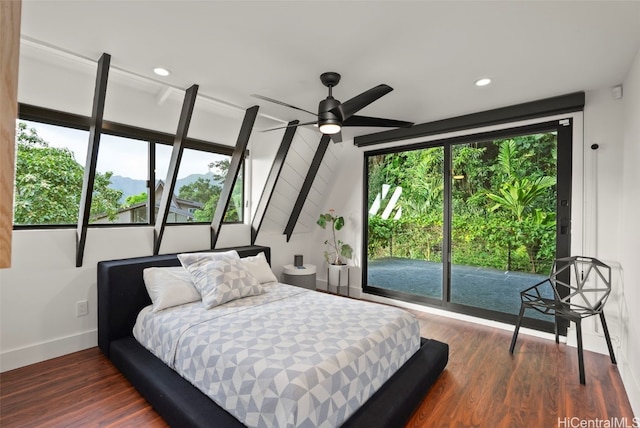 bedroom featuring dark wood-type flooring, multiple windows, and access to exterior