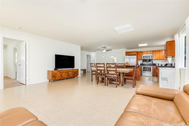 living room featuring light tile patterned floors and ceiling fan