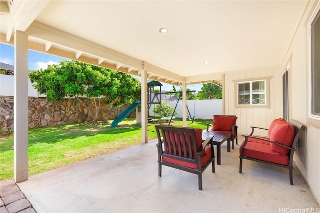 view of patio / terrace featuring an outdoor living space, a playground, and a fenced backyard