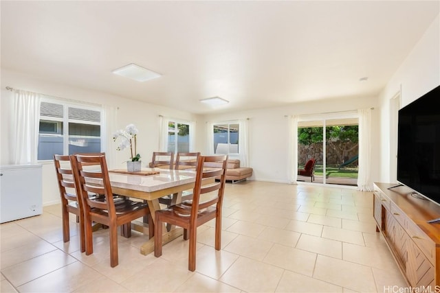 dining space with light tile patterned floors and baseboards