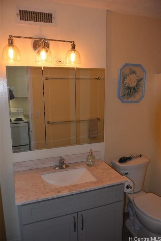 bathroom featuring visible vents, vanity, and toilet