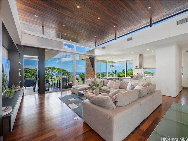 living area featuring wood ceiling, a wall of windows, wood finished floors, and visible vents