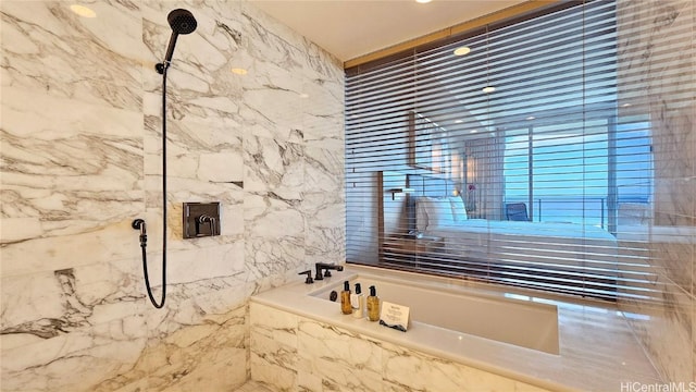 full bathroom with walk in shower, a tub with marble appearance, and tile walls