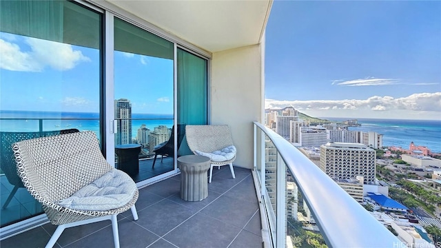 balcony with a water view and a city view