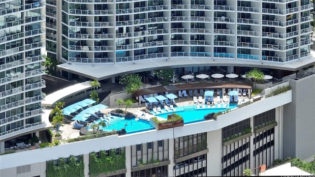 view of building exterior featuring a community pool