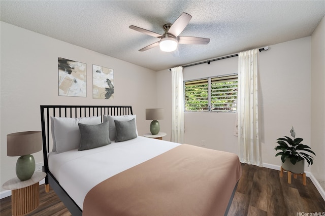 bedroom featuring a textured ceiling, ceiling fan, baseboards, and dark wood-type flooring