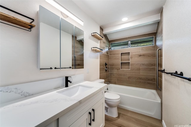 bathroom with toilet, vanity, washtub / shower combination, and wood finished floors