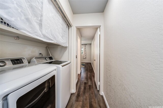 washroom featuring dark wood-style floors, laundry area, a textured wall, baseboards, and washer and dryer
