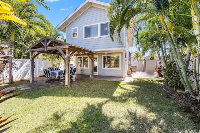 back of house featuring a gazebo, a lawn, a patio area, and a fenced backyard