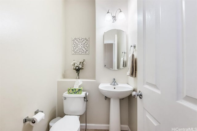 bathroom featuring toilet and a sink