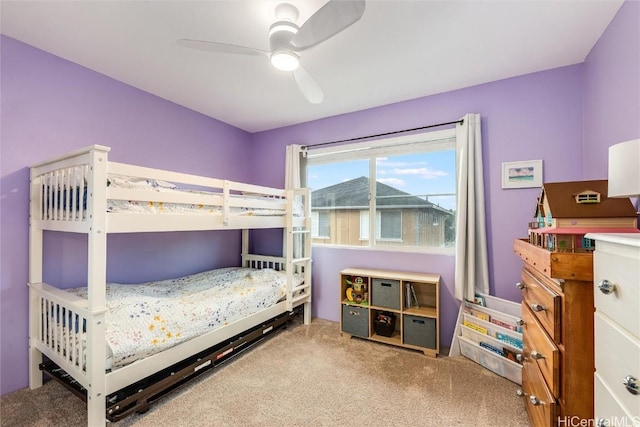 bedroom with a ceiling fan and carpet