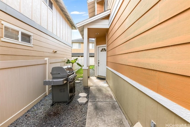 view of patio / terrace featuring a grill and fence