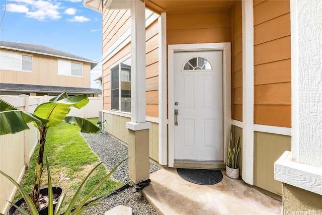 doorway to property featuring fence