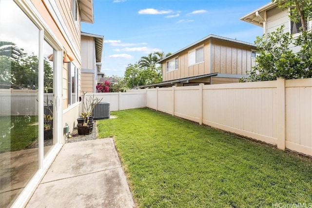 view of yard with central AC unit, a fenced backyard, and a patio area