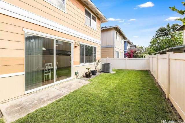 view of yard with central AC unit and a fenced backyard