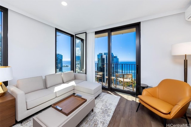 living area featuring a view of city, a water view, light wood-style flooring, and expansive windows