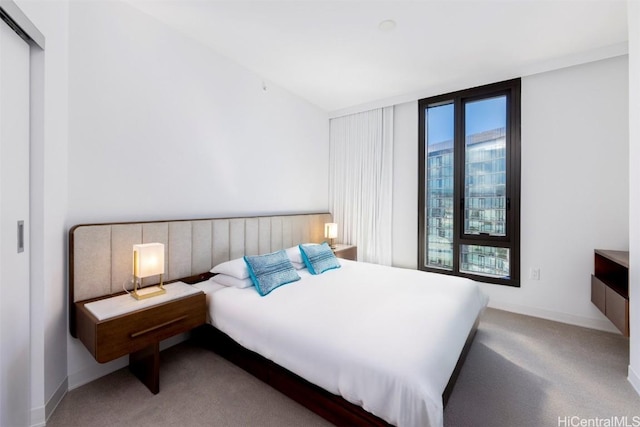 bedroom featuring carpet and baseboards