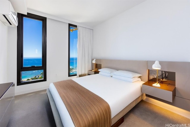 bedroom featuring carpet floors, baseboards, and a wall mounted AC