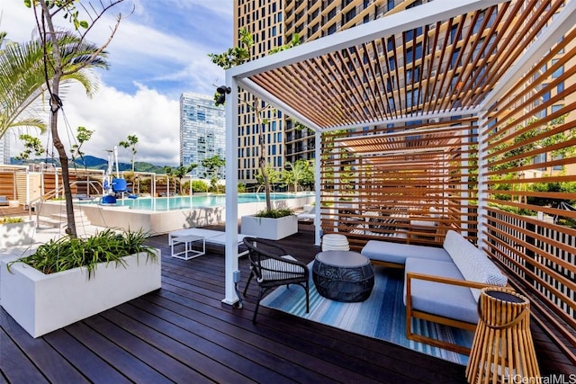 deck with a view of city, a pergola, an outdoor living space, and a community pool