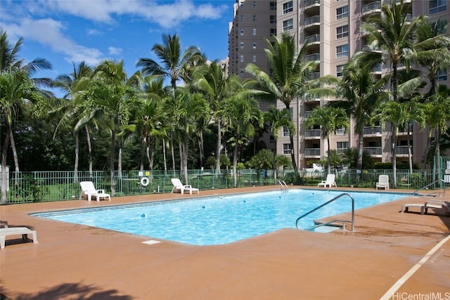 community pool featuring a patio area and fence