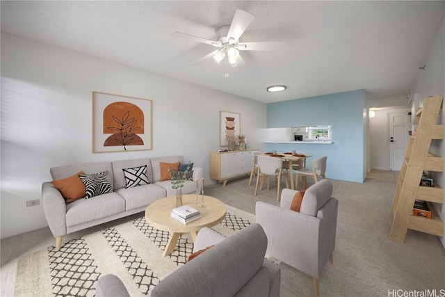 living room featuring ceiling fan and light colored carpet