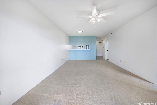 unfurnished living room with carpet floors and a ceiling fan