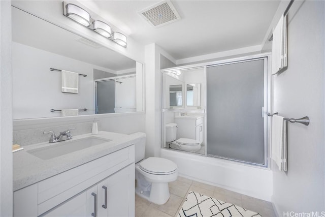 bathroom with visible vents, toilet, enclosed tub / shower combo, tile patterned flooring, and vanity