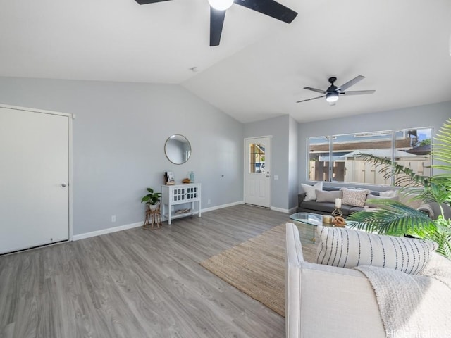 unfurnished living room with baseboards, vaulted ceiling, light wood finished floors, and ceiling fan