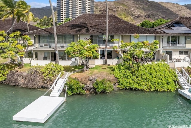 rear view of property featuring a water and mountain view