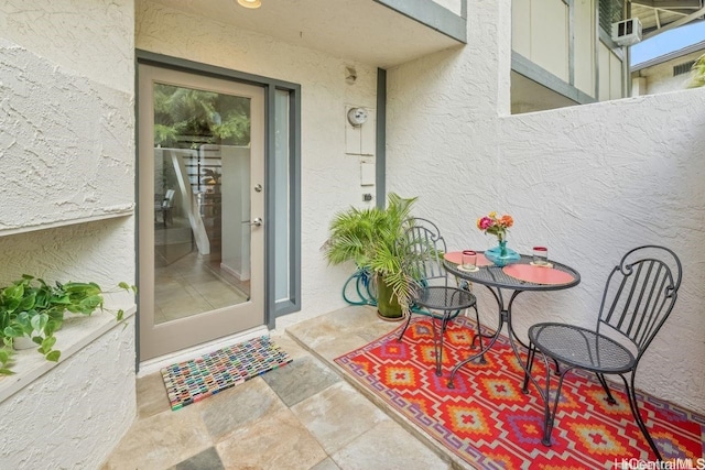 property entrance with stucco siding