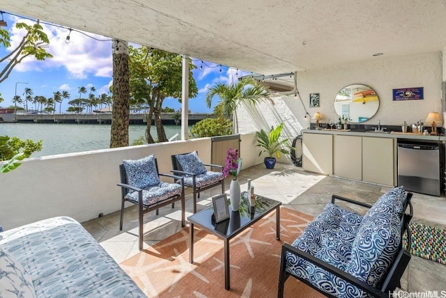 sunroom featuring a water view, wet bar, and a sink