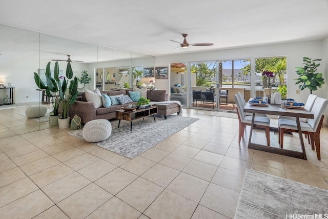 living area featuring ceiling fan and light tile patterned flooring