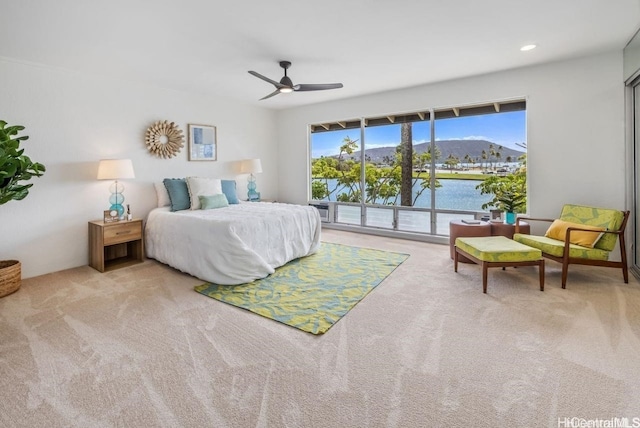 bedroom featuring light colored carpet, ceiling fan, access to outside, a water and mountain view, and recessed lighting