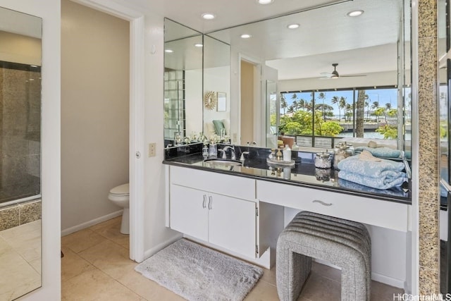 bathroom featuring baseboards, toilet, ceiling fan, tile patterned flooring, and vanity