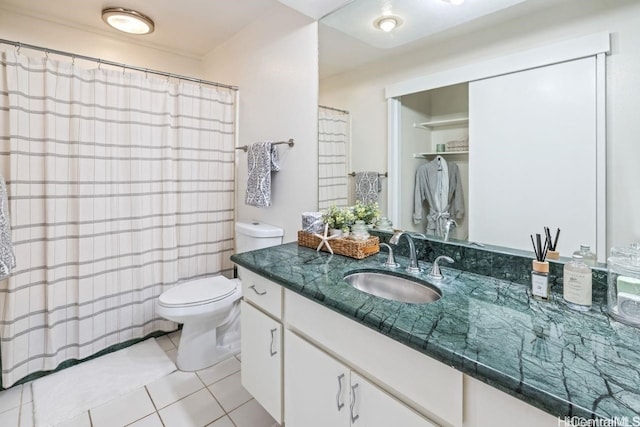 bathroom featuring toilet, vanity, and tile patterned floors