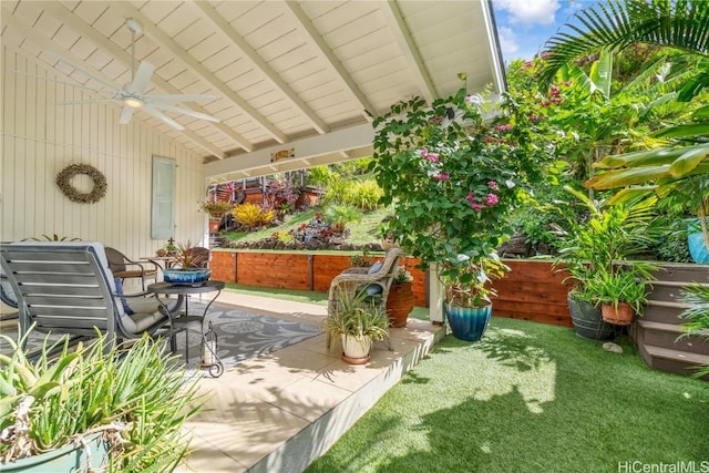 view of patio / terrace with ceiling fan and fence