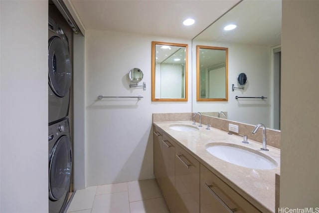 full bathroom featuring double vanity, stacked washing maching and dryer, a sink, and recessed lighting