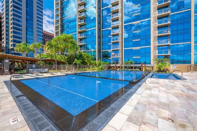 pool featuring a patio area and fence