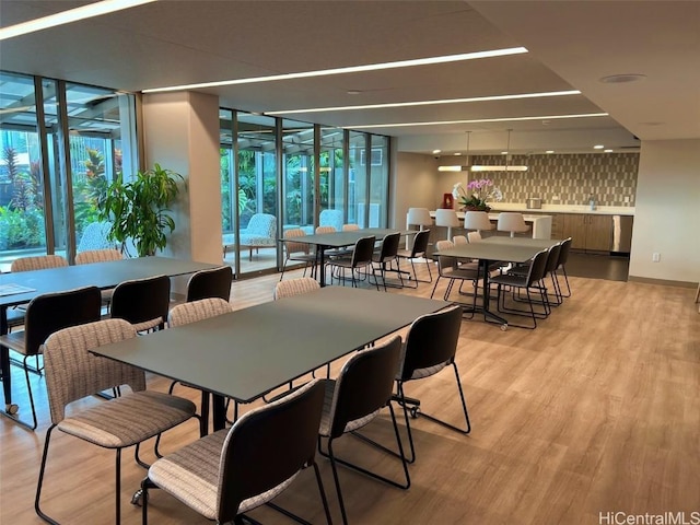 dining area featuring light wood finished floors and floor to ceiling windows