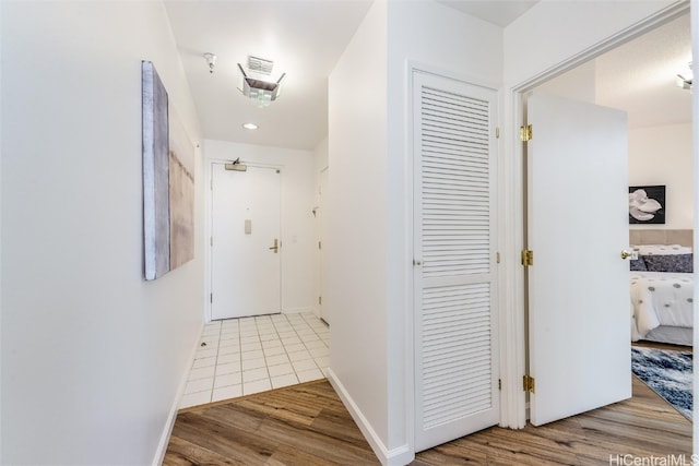 hall featuring baseboards and wood finished floors