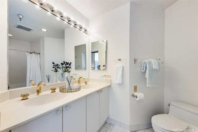 bathroom featuring toilet, baseboards, visible vents, and a sink