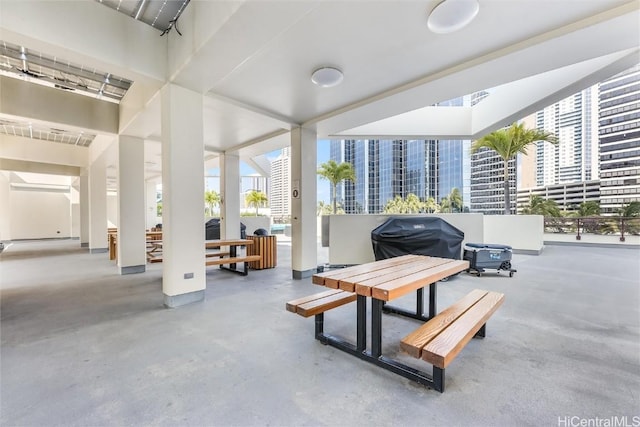 interior space featuring outdoor dining space, a city view, and a patio