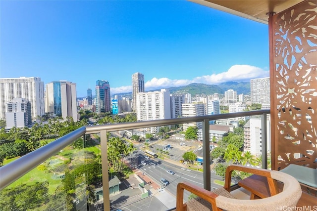 balcony with a view of city and a mountain view